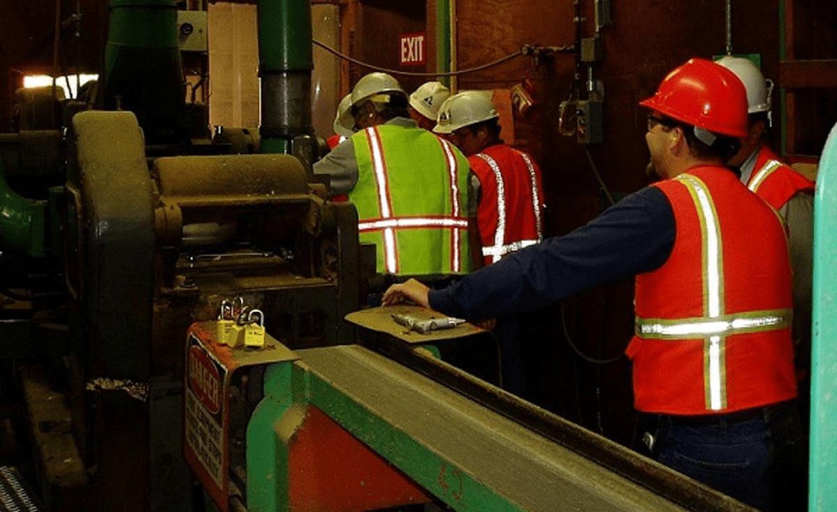 Workers wearing safety vests in industrial setting
