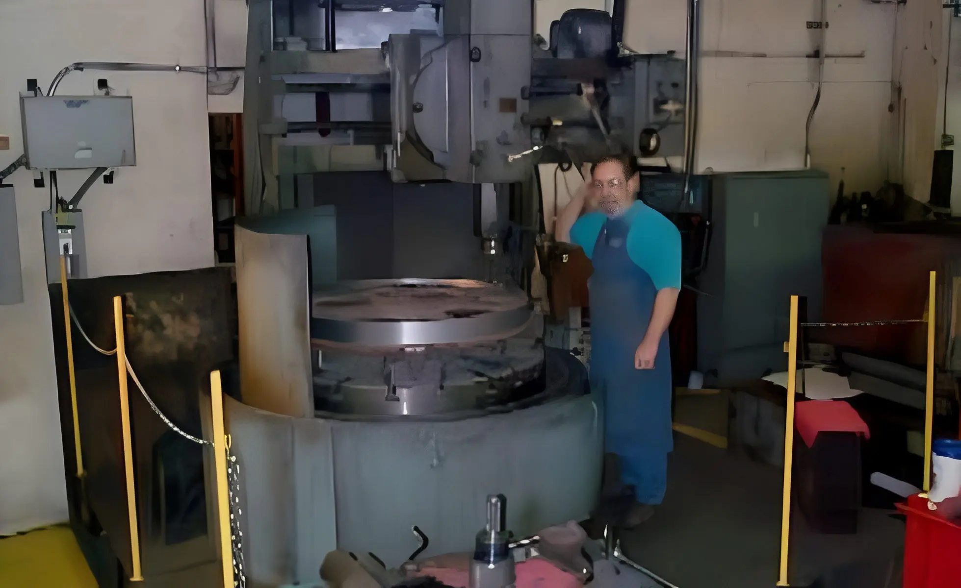 Worker beside large metal machine